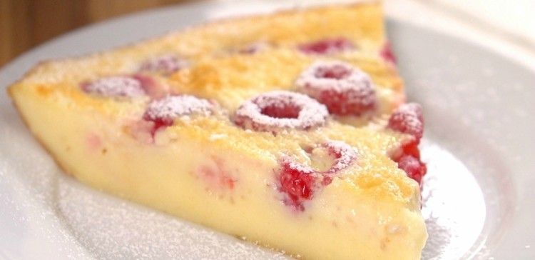 Close-up of slice of raspberries in baked custard called clafoutis