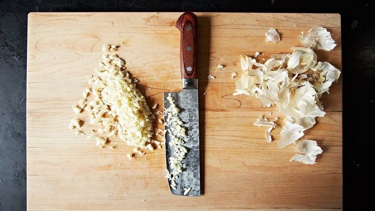 knife minced garlic cutting board