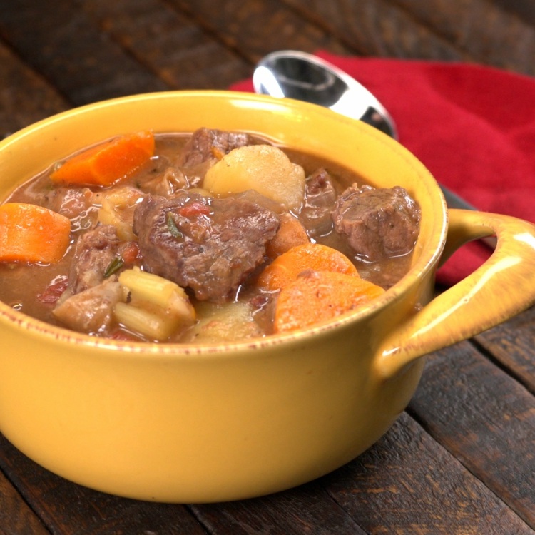 Yellow bowl of beef stew made in slow cooker