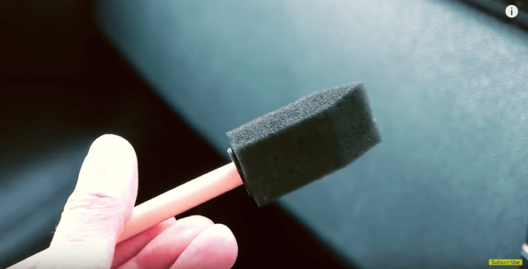 Using a sponge brush to clean air vent.