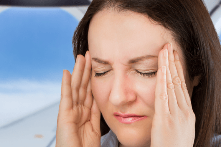 woman with a headache on an airplane