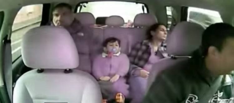 family in the backseat of a taxi