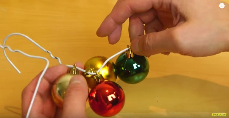 Putting ornaments on your DIY wreath.