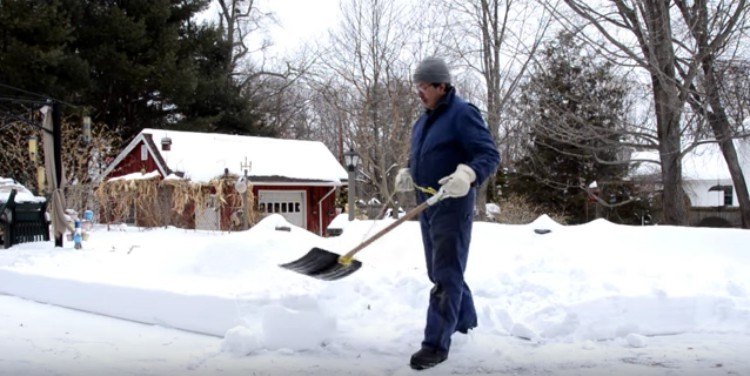 man shoveling with rope shovel