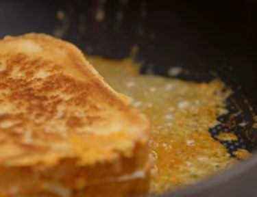 Frying grilled cheese to give it cheese crust