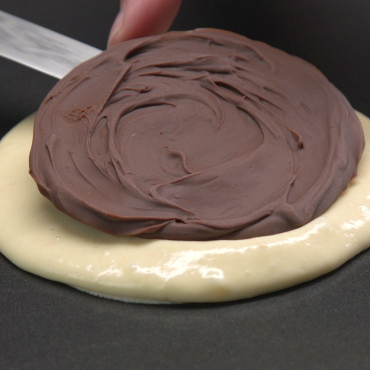 Place 1 frozen Nutella disc into the center of the batter
