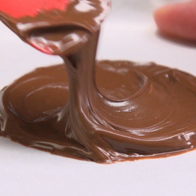 Spoon 1-½ Tbs. Nutella onto the prepared pan and spread out into a round disc about 2-/1/2” in diameter