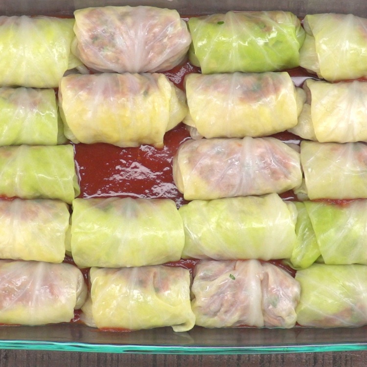 Place cabbage rolls in the prepared baking dish, seam side down