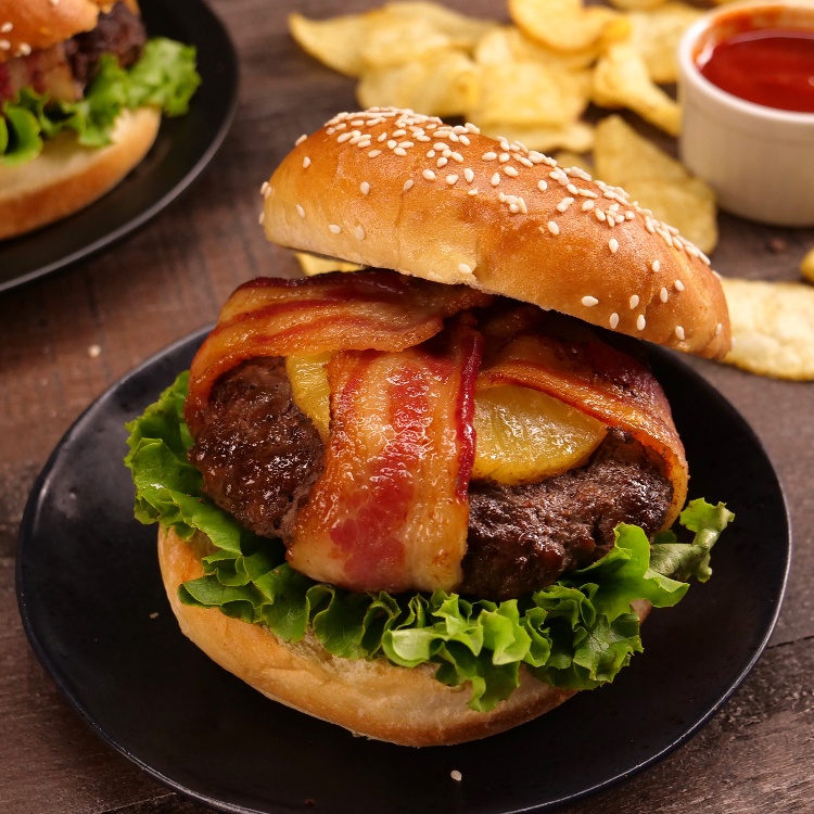 You know what they say: "Good things come in bacon-wrapped packages." Even better when it's a sweet & smoky BBQ burger topped with caramelized pineapple.