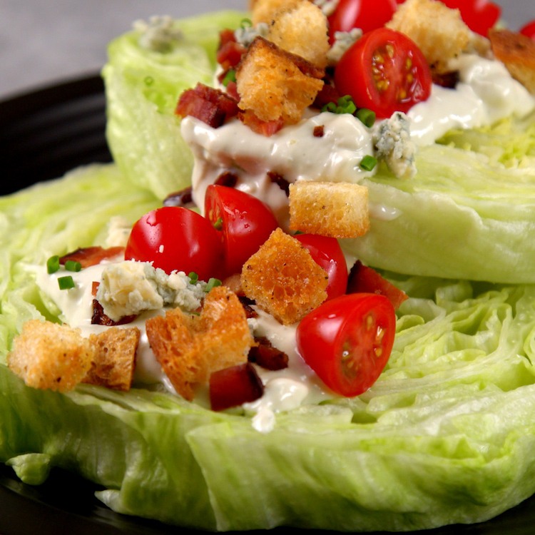 Chilled, crisp iceberg lettuce covered in creamy blue cheese dressing, bacon, croutons, & tomatoes--plus one new twist that makes this the ultimate wedge salad.