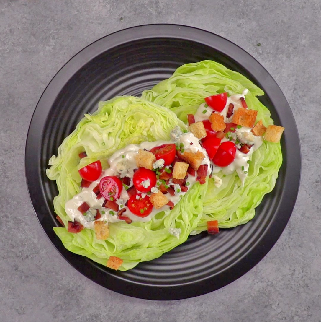Chilled, crisp iceberg lettuce covered in creamy blue cheese dressing, bacon, croutons, & tomatoes--plus one new twist that makes this the ultimate wedge salad.