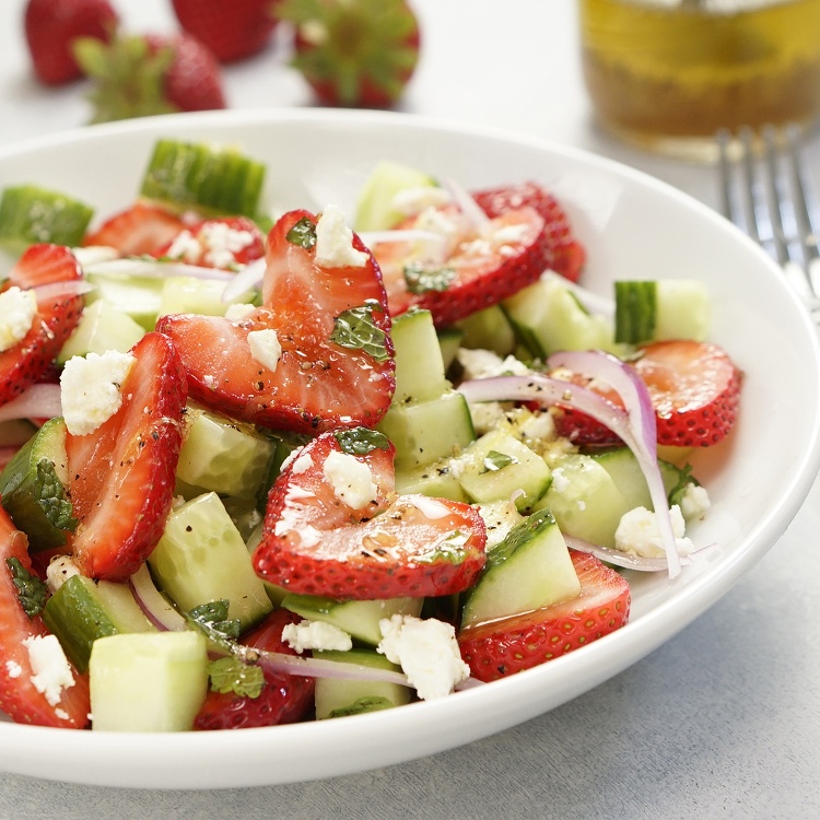 Fresh and easy summer salad with ripe strawberries, cucumbers, mint, red onions, and feta cheese tossed with a zesty homemade honey lemon salad dressing.