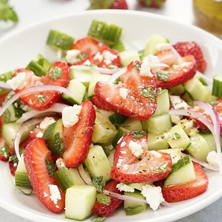 Fresh and easy summer salad with ripe strawberries, cucumbers, mint, red onions, and feta cheese tossed with a zesty homemade honey lemon salad dressing.
