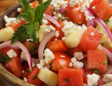 Healthy, refreshing, and unexpected Mediterranean summer salad with mellow watermelon, cucumber, tomatoes, zingy red onion, feta cheese, and cool mint.