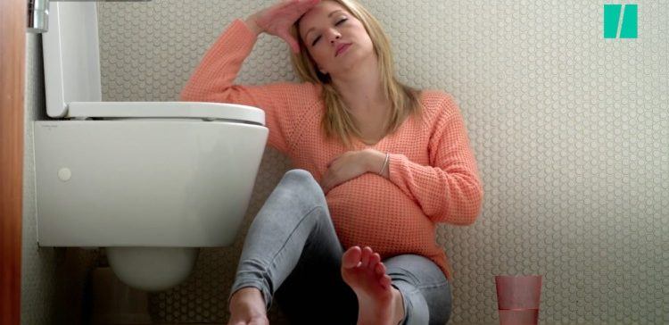 Image of sick woman next to toilet.