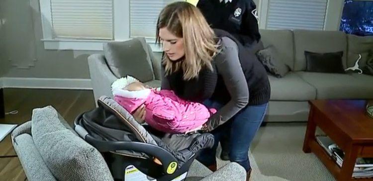 Image of mom putting baby in car seat.