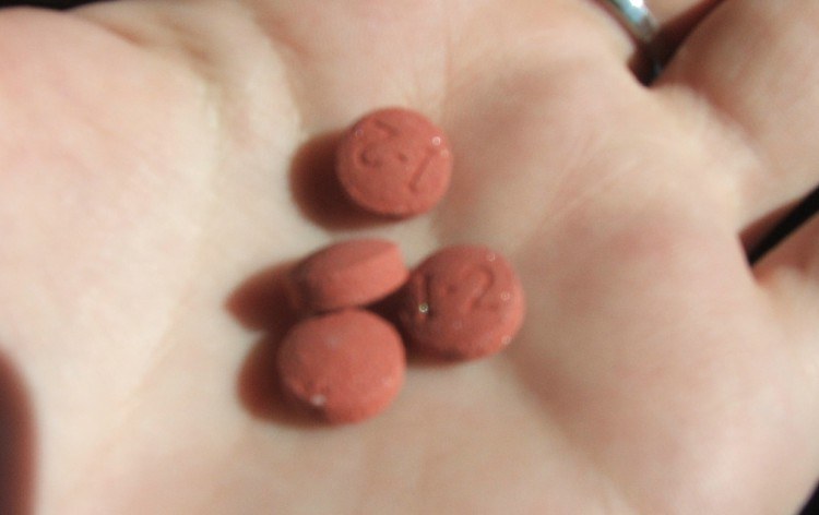 Image of pills in hand.