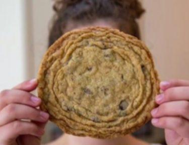woman holds panbanging cookie in front of face