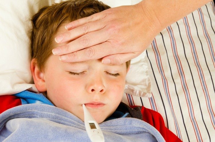 Image of child with thermometer in mouth.