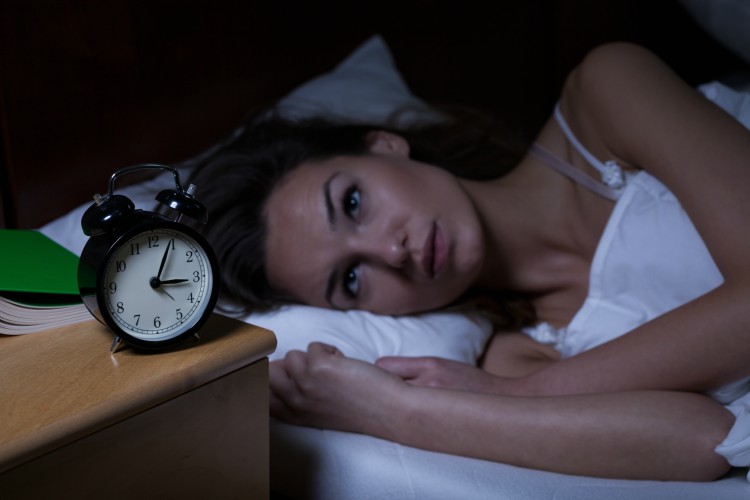 Image of woman in bed awake.
