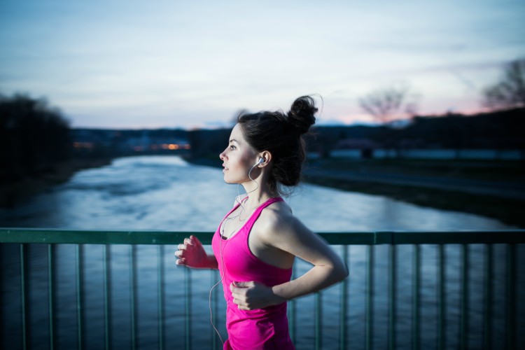 Image of woman jogging outside at dusk.