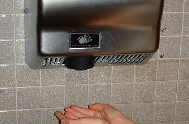 hands drying under hand dryer