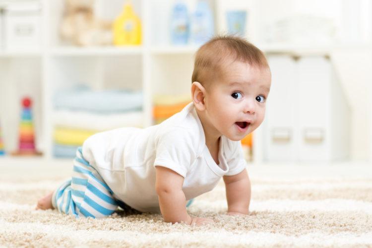 Image of crawling funny baby boy indoors at home