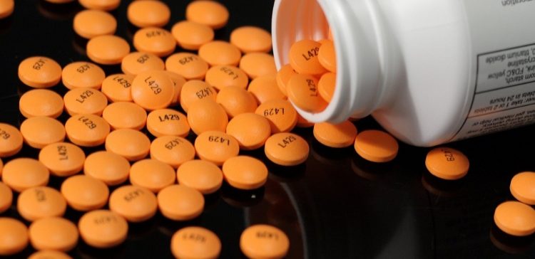 orange pills on black background