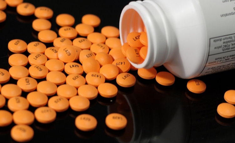 orange pills on black background