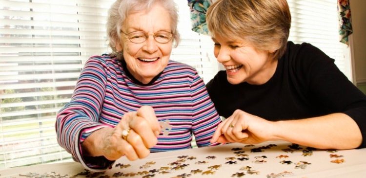 Image of mom and daughter working on a puzzle