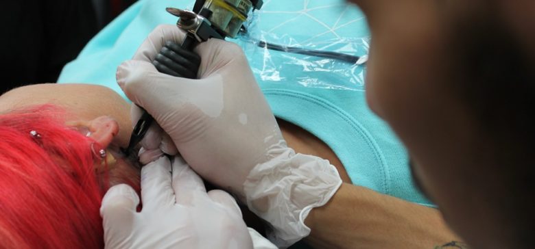 Image of woman getting tattoo.