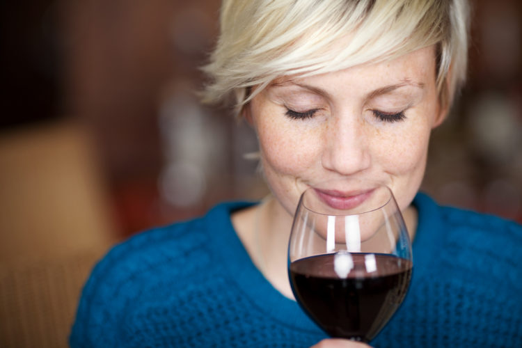 Image of closeup portrait of young female customer drinking red wine with eyes closed