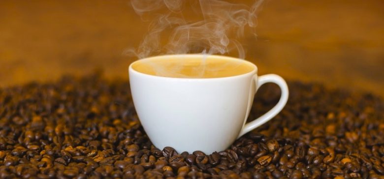 Image of coffee mug in coffee beans
