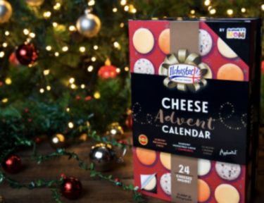 cheese advent calendar in front of a Christmas tree