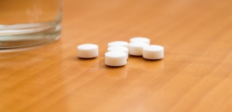 Image of pills or medicine on nightstand.