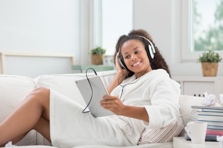 woman on ipad with headphones