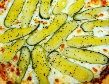 Image of pickles on a pizza pie