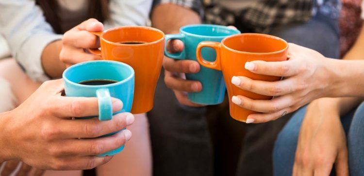Image of Group of friends making a toast with coffee