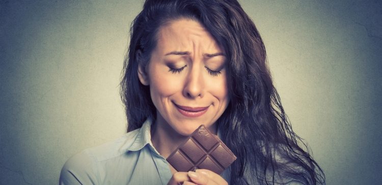Image of girl looking at a bar of chocolate