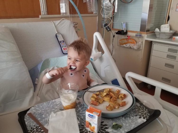Image of little boy eating at hospital
