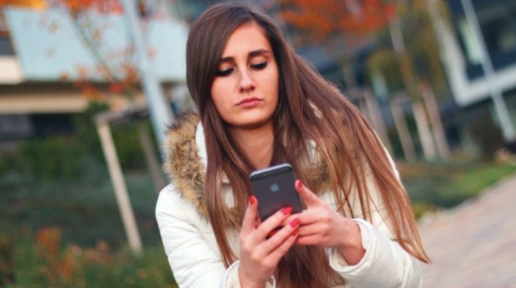 girl looking at a cell phone