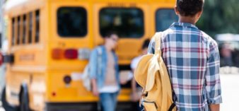 Image of kid walking to school bus.
