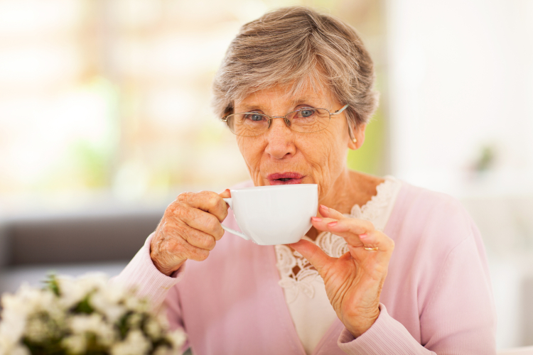 Image of senior woman drinking tea at home